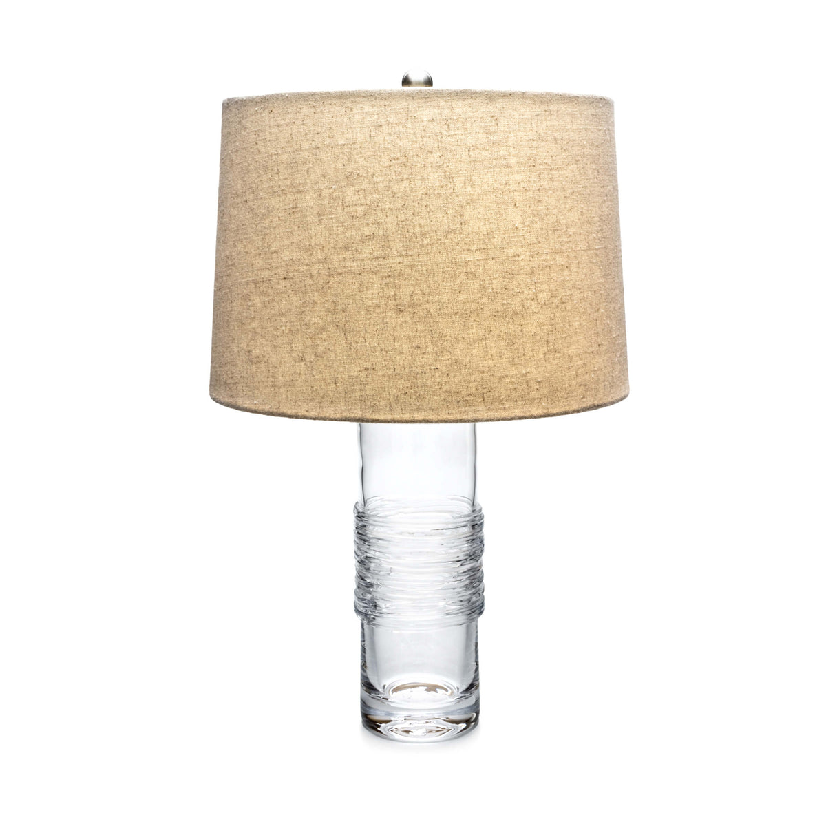 Table lamp with clear glass cylindrical base wrapped in textured wire and tan linen drum shade.