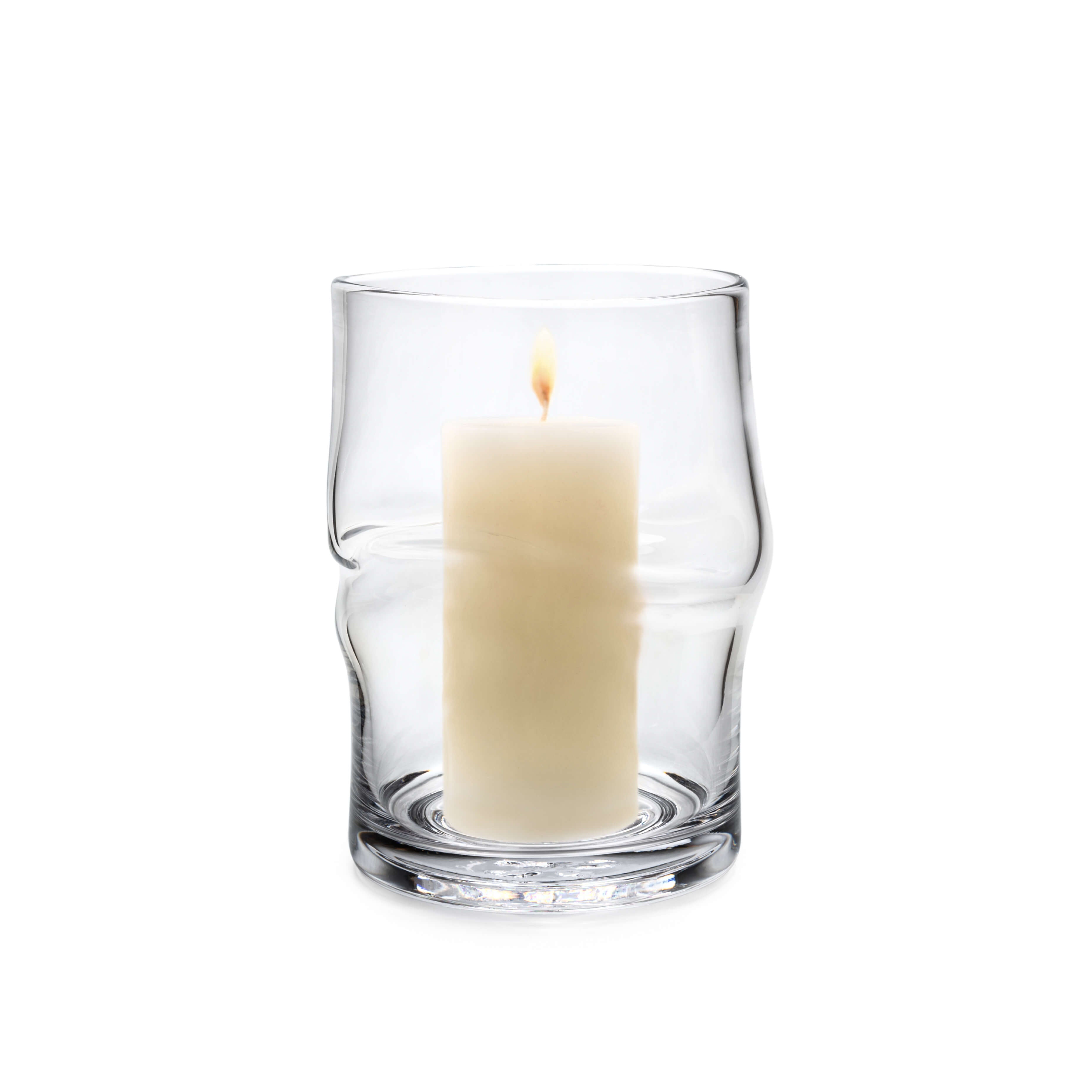 Clear glass hurricane with twisted sides holding a lit cream-colored pillar candle.