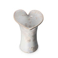 Clear crystalline vase with calla lily-shaped opening and embossed circular pattern throughout body.