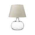 Clear glass round base lamp with cream linen tapered shade.