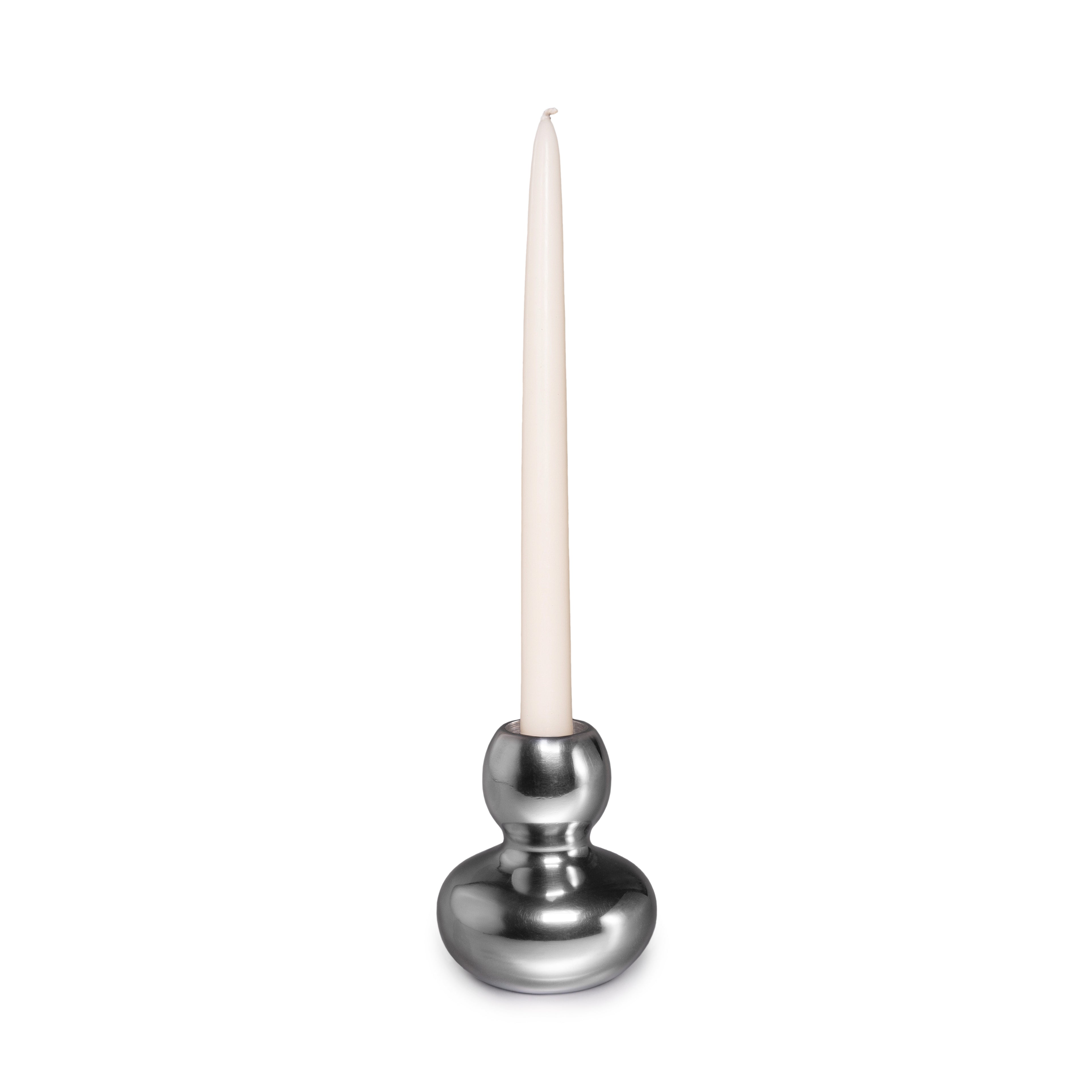Silver aluminum candlestick with spherical base and tapered cream candle inserted in socket.