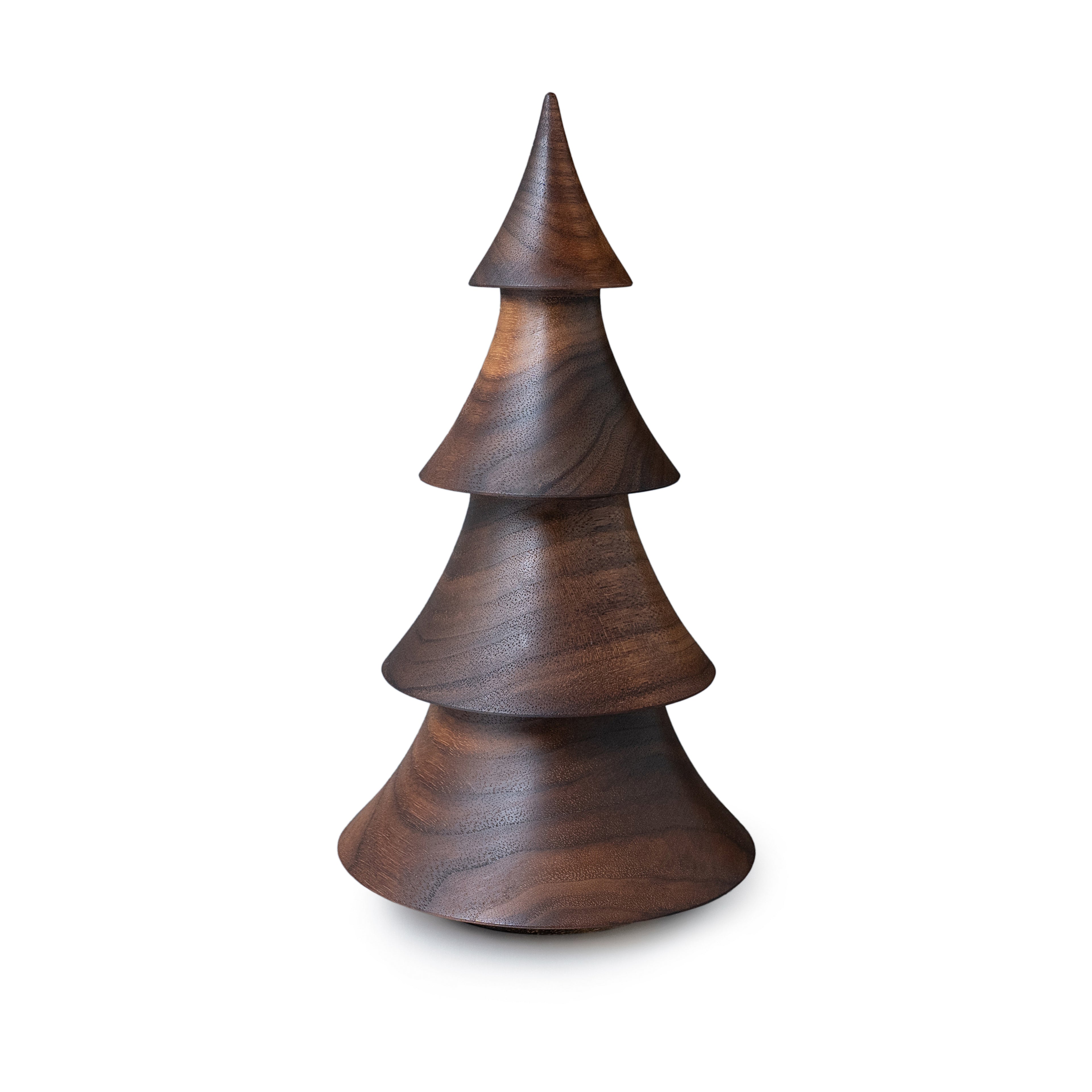 Stacked walnut wood evergreen tree sculpture with pointed top and tiered cone sections.