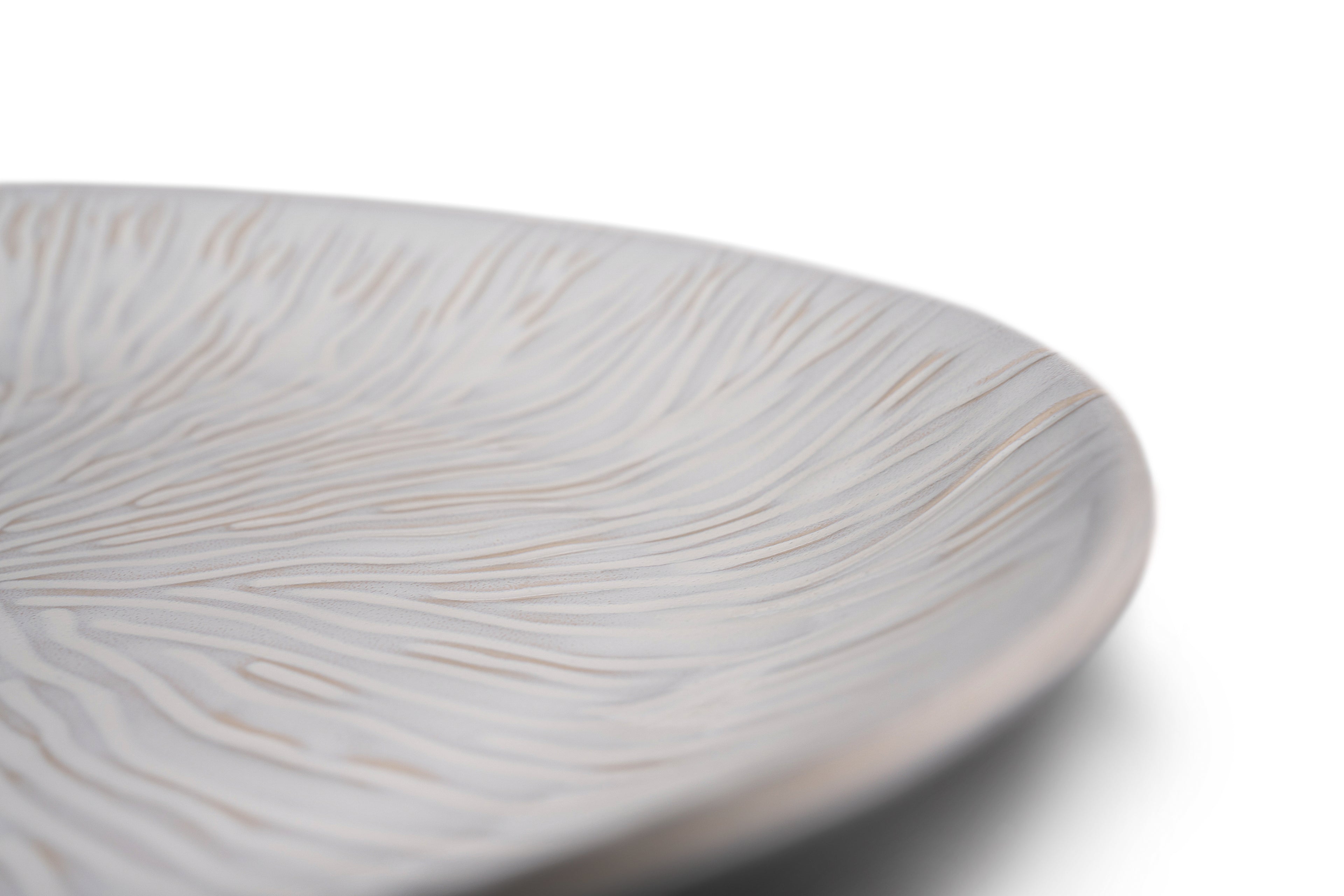 White ceramic platter with linear leaf-textured surface and subtle beige accents.
