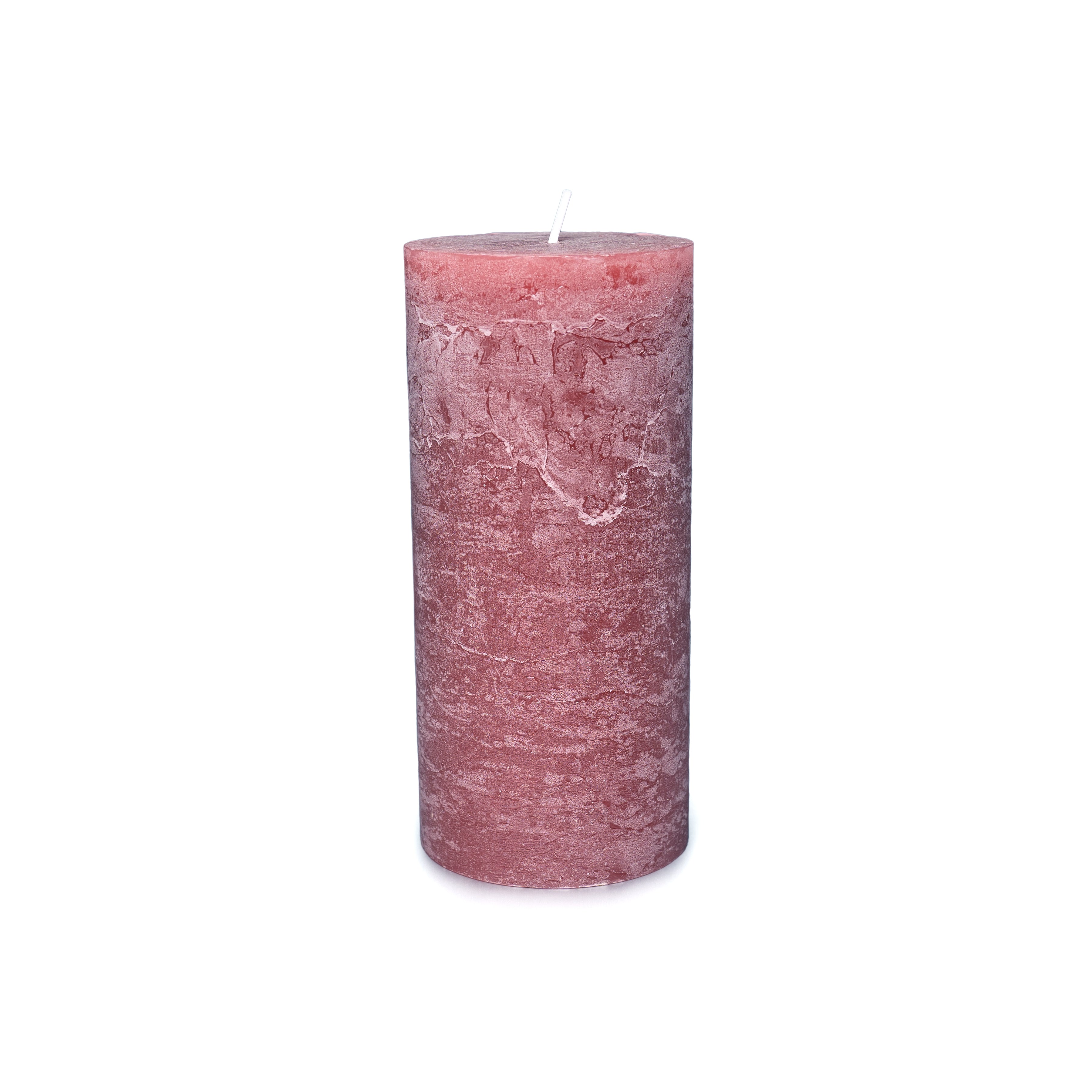 Cylindrical pillar candle in dusty rose pink with textured surface and white wick.