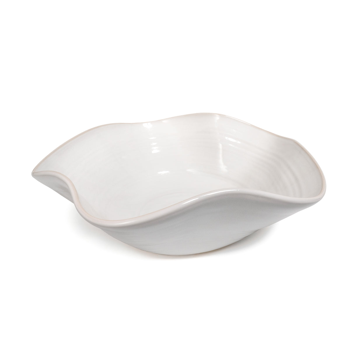 White ceramic bowl with wavy, asymmetrical edges and curved sides.