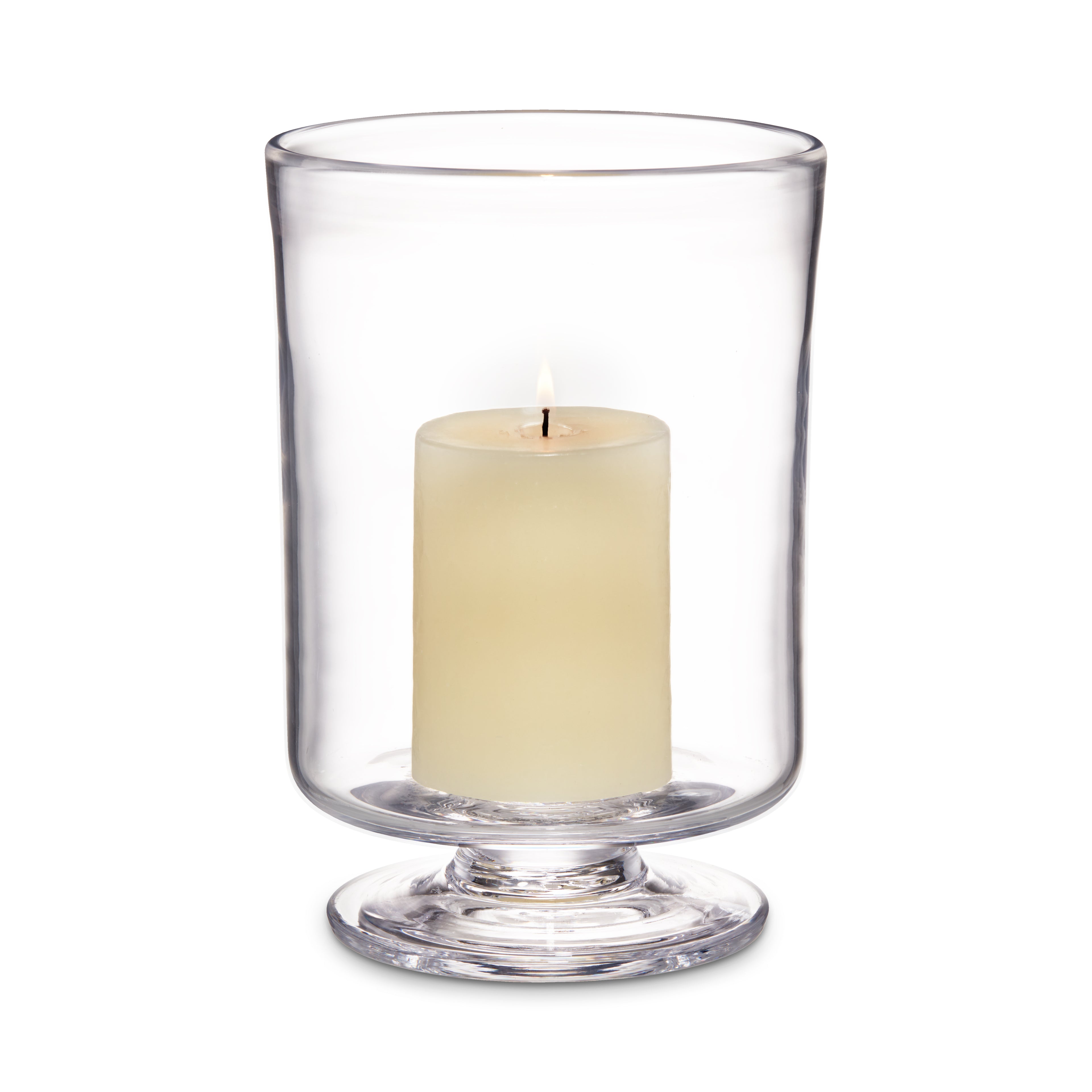 Clear glass hurricane with cream-colored pillar candle inside on pedestal base.