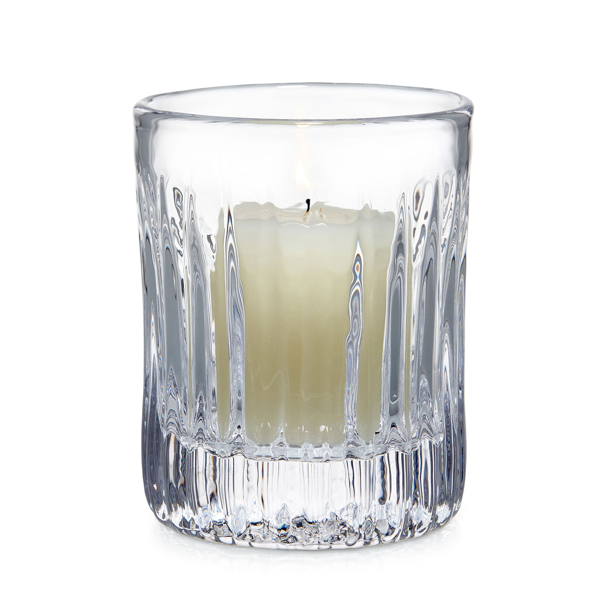 Clear glass hurricane with vertical ribbed pattern and cream-colored candle inside.