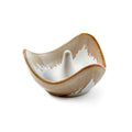 Curved ceramic ring holder with a white cone post, tan and white glaze finish.