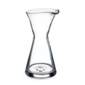 Clear glass pitcher with hourglass shape and pouring spout.
