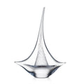 Clear glass sailboat sculpture with tall mast and curved hull base.