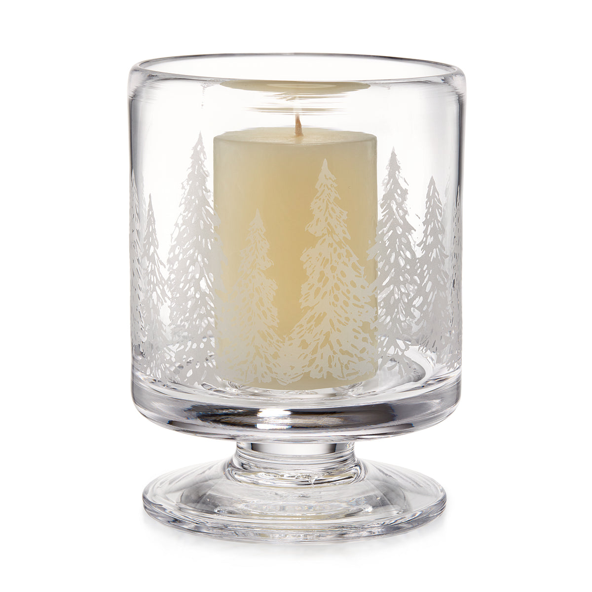 Clear glass hurricane candle holder with engraved forest tree design and cream-colored pillar candle inside.