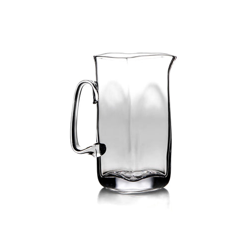 Clear glass pitcher with curved handle and tapered rectangular body.