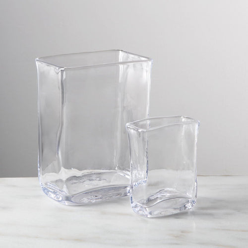 Two clear glass rectangular vases in different sizes with curved sides and rounded bases.