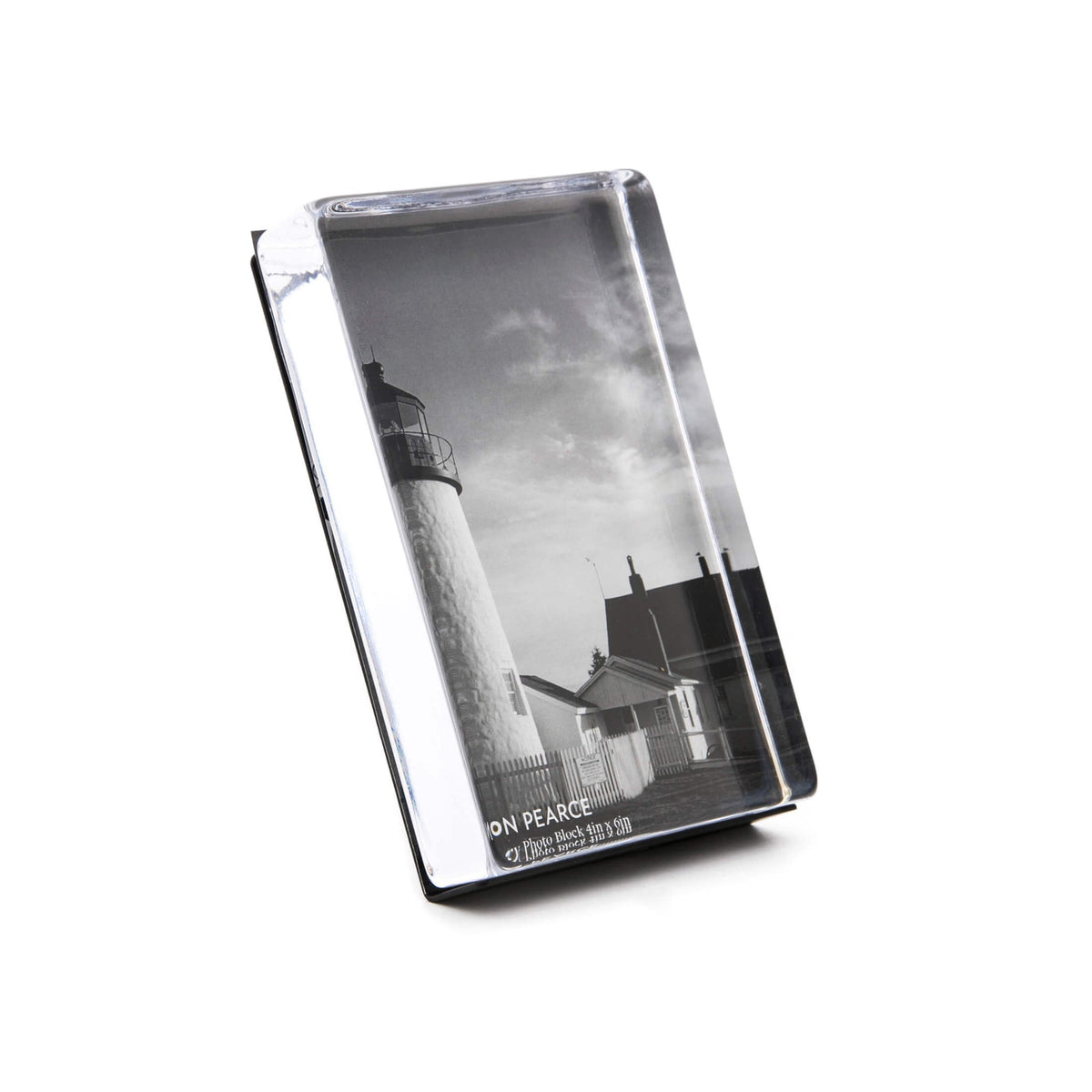 Vertical photo block with black and white lighthouse image, clear acrylic front, and black stand base.