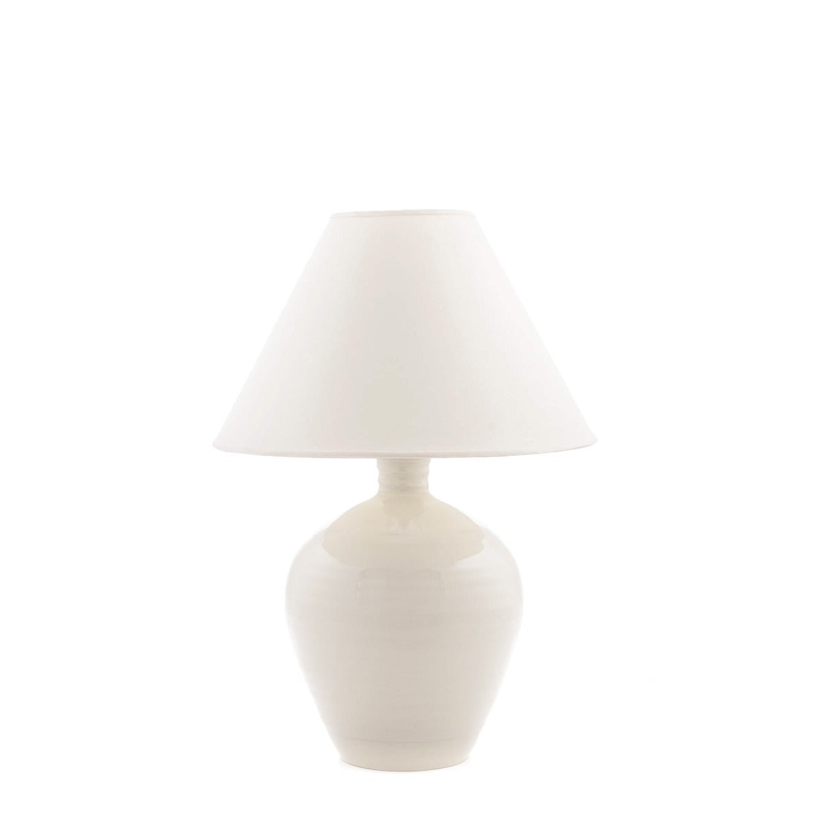 Ivory ceramic table lamp with crackle finish, bulbous base, and tapered linen shade.