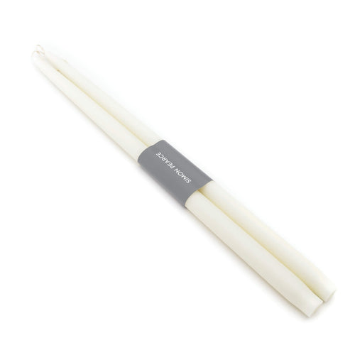 Two ivory taper candles bundled together with a gray paper band labeled "Spice Novalis".