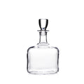 Clear glass decanter with rounded rectangular body, narrow neck, and matching glass stopper.