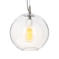 Clear glass globe pendant with brushed nickel hardware and glowing yellow filament bulb inside.