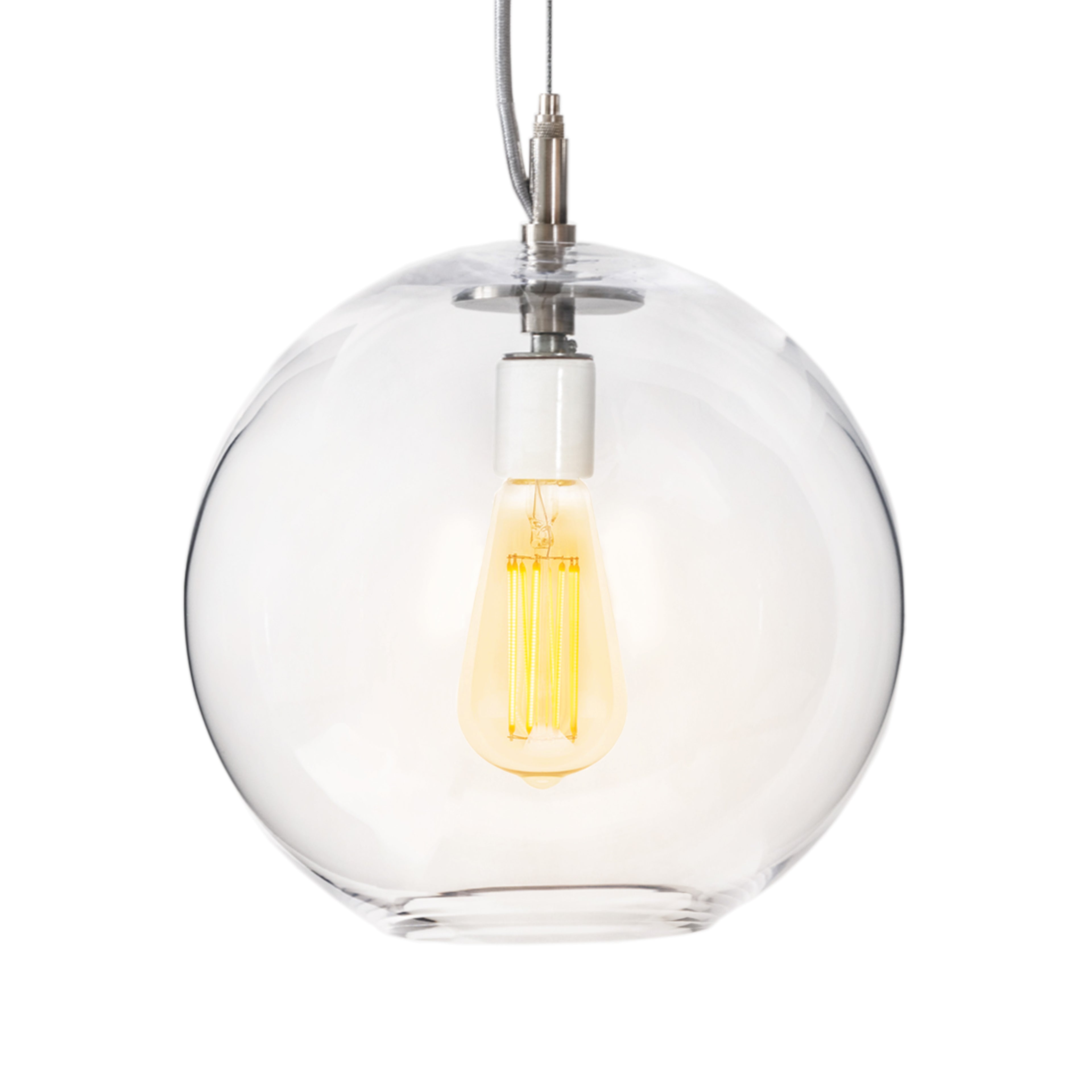 Clear glass globe pendant with brushed nickel hardware and glowing yellow filament bulb inside.