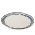 Shallow ceramic bowl with cream center and blue-gray textured rim.