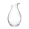 Clear glass carafe with curved teardrop shape and angled pouring spout.