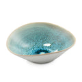 Shallow ceramic bowl with lagoon blue glaze and speckled interior pattern on white exterior.
