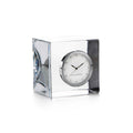 Round silver clock with white dial and black hands mounted on clear crystal block with black base panels.