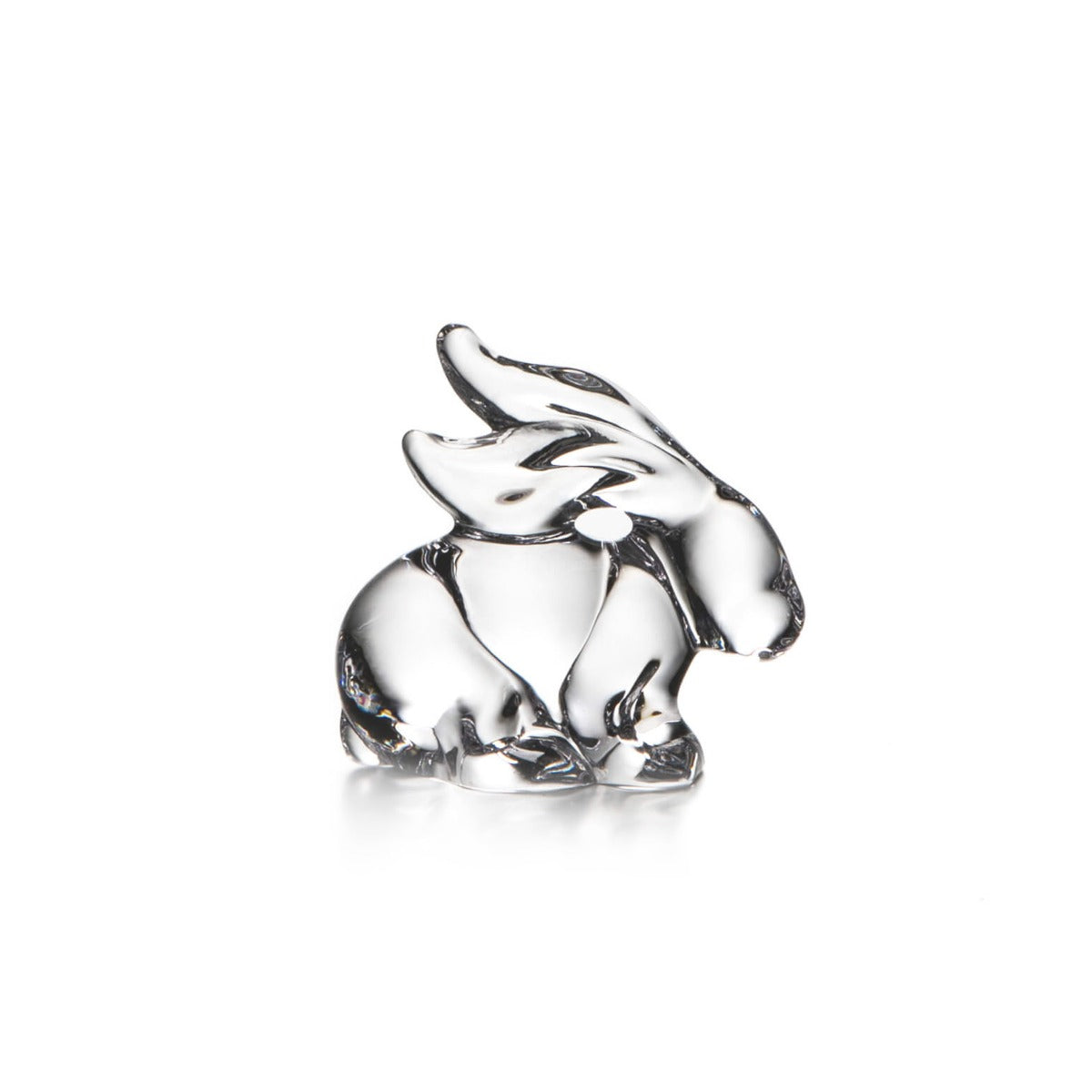 Clear glass rabbit figurine with upright ears and sitting posture on white background.