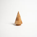 Wooden cone-shaped evergreen figurine in natural maple wood with a cylindrical base on white background.