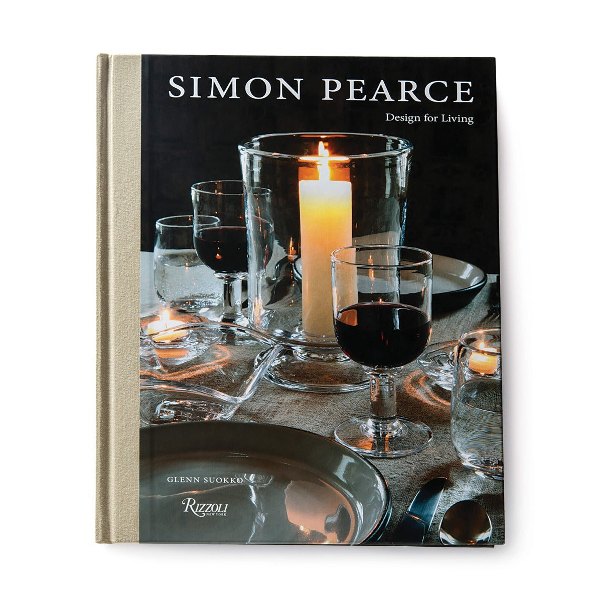 Hardcover book with black cover featuring glassware, lit candle, wine glass, and place settings on table.