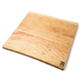 Cherry wood cutting board with natural grain and live edges, rectangular shape with rounded corners and brand logo on bottom 