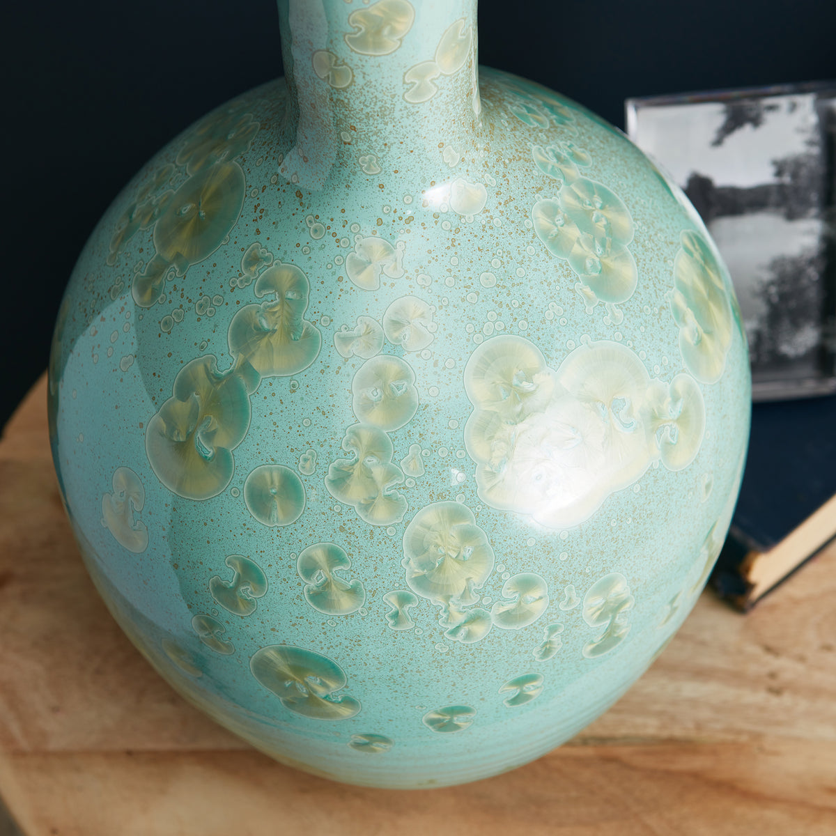 Turquoise spherical lamp base with jellyfish-pattern etched design and metallic accents.