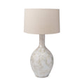 White crystalline ceramic table lamp with cylindrical linen shade.