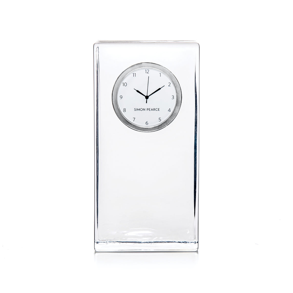 Clear tall rectangular clock with circular dial showing Simon Pearce branding and black hands.