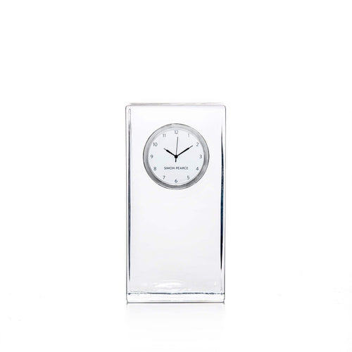 Clear crystal tall clock with round white dial and Arabic numerals, branded Simon Pearce.