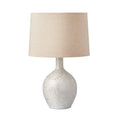 White textured ceramic table lamp with cream linen drum shade.