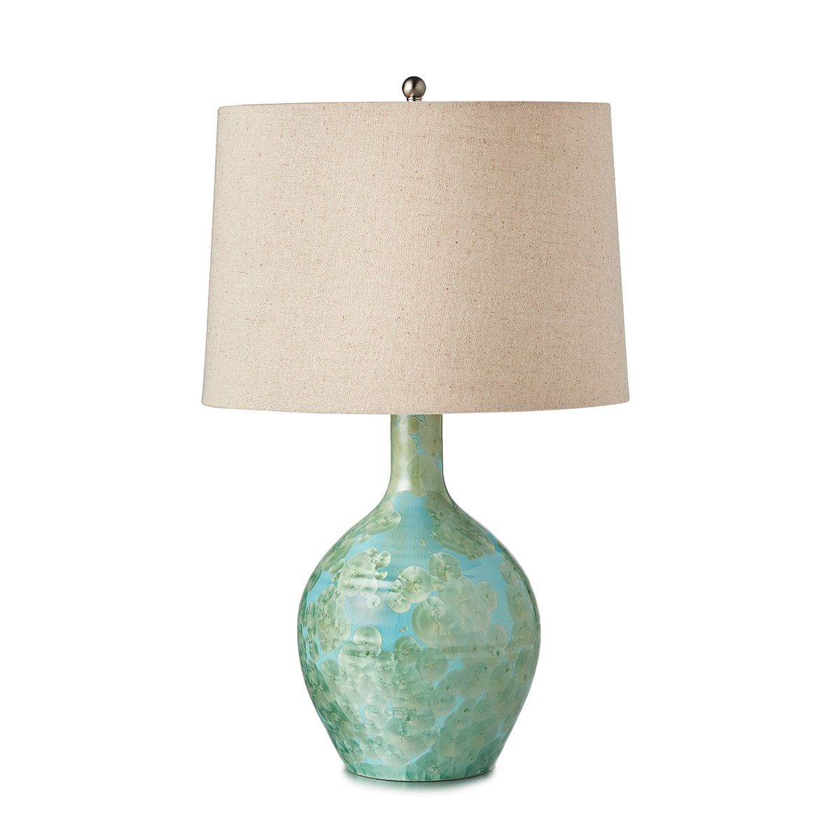 Table lamp with blue-green textured ceramic base and cream linen drum shade.