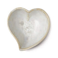 Heart-shaped bowl with crystalline white interior and tan-colored rim and exterior.