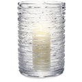 Clear textured glass hurricane vase with horizontal ridged pattern and cream-colored interior coating.