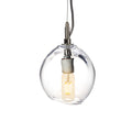 Clear glass globe pendant with exposed filament bulb and dark metal fixture suspended from black cord.