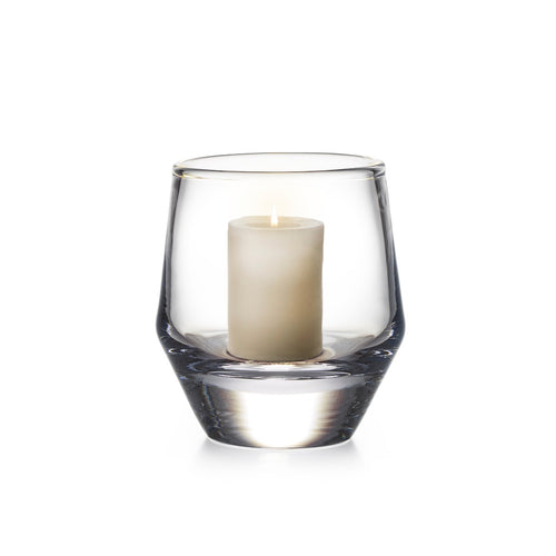 Clear glass hurricane vase with cream pillar candle inside.