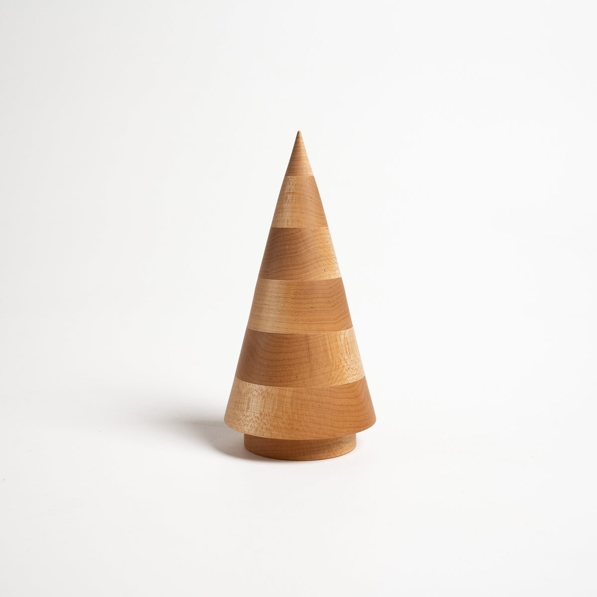 Wooden cone-shaped evergreen decoration with stacked band details and natural maple finish.