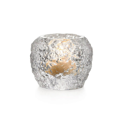 Silver textured tealight holder with lit candle visible inside.