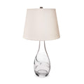 Table lamp with clear glass teardrop base and cream linen tapered shade with bronze finial.