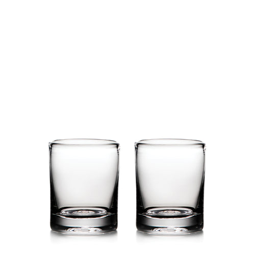 Two clear glass whiskey glasses with thick bases, empty and positioned side by side.