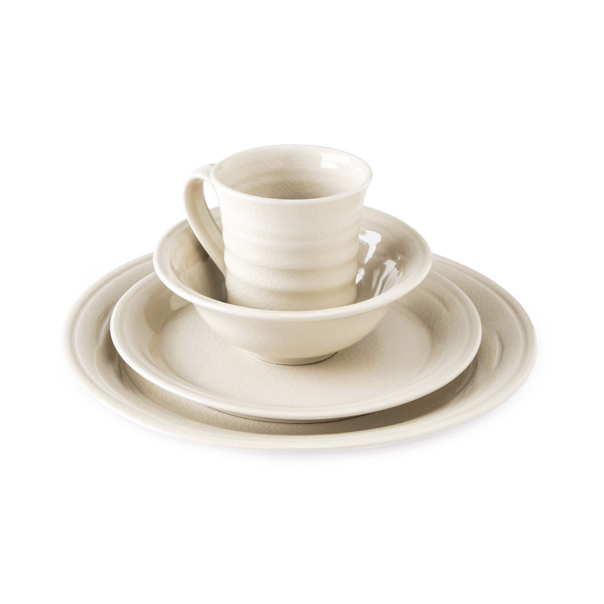 Ivory ceramic dinnerware set with textured crackle finish includes plates, bowl, and mug.