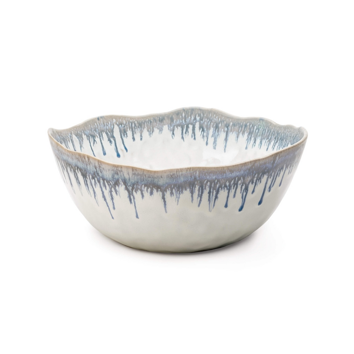 White ceramic serving bowl with blue drip glaze pattern and wavy rim edge.