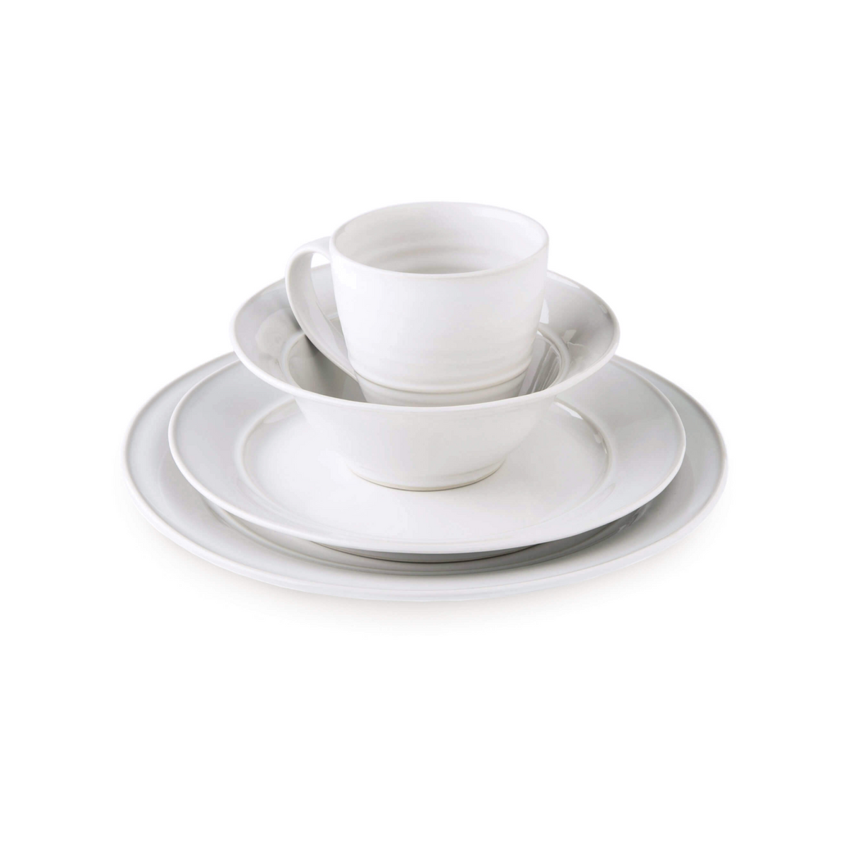 White ceramic dinnerware set stacked with dinner plate, bowl, cup, and saucer.