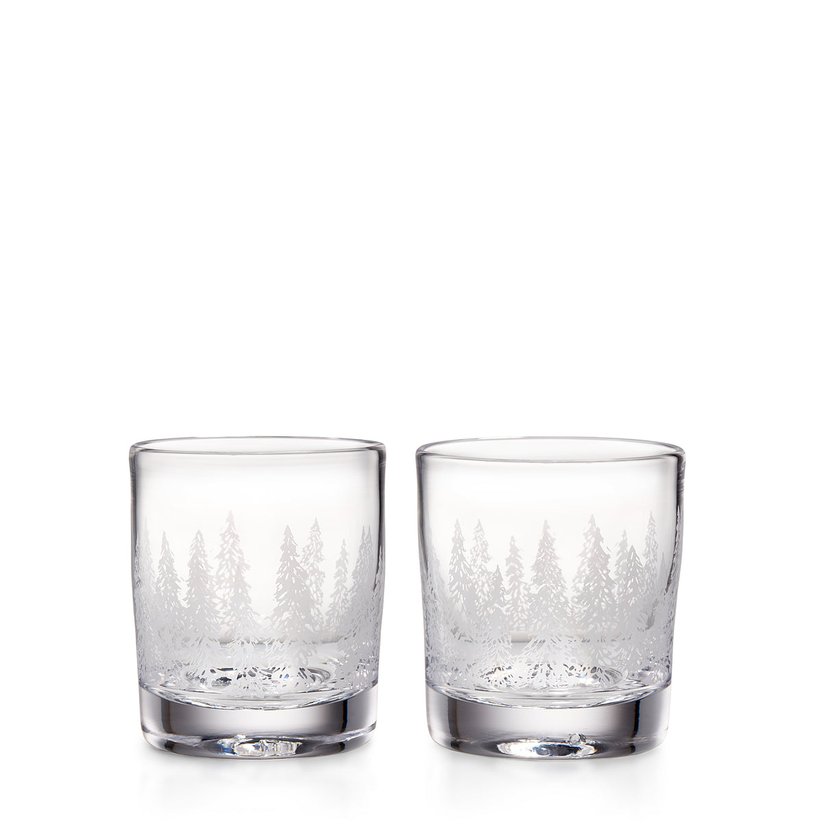 Two clear double old-fashioned glasses with engraved forest and mountain design around the lower portion.