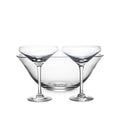 Two clear coupe glasses with wide bowls and a matching empty bowl, arranged on white background.